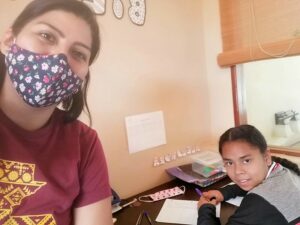 Alejandra doing school work with Karen.