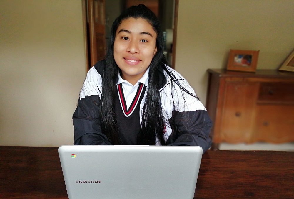 Aracely doing school at Dorie's Promise via laptop